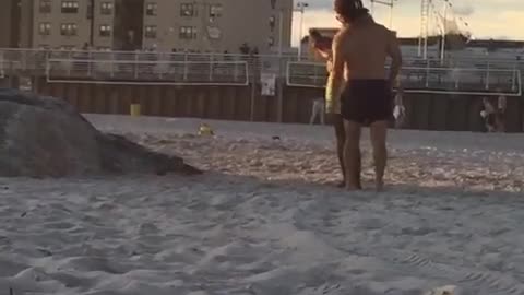 Guy in neon green shorts takes picture of friend jumping off rocks