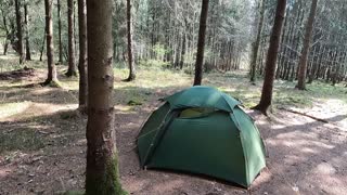 Firepit and tent in the morning of a wildcamp