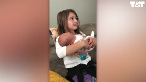 Girl is meet newborn sister for the first time