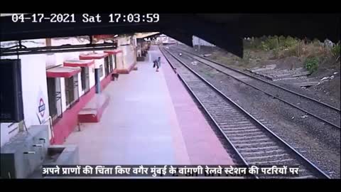 A brave man saves a young boy from a train coming to India