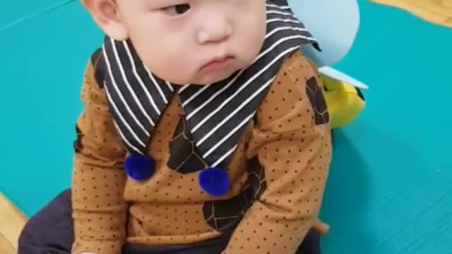 This is a video of a baby dressed as a bee and having fun.