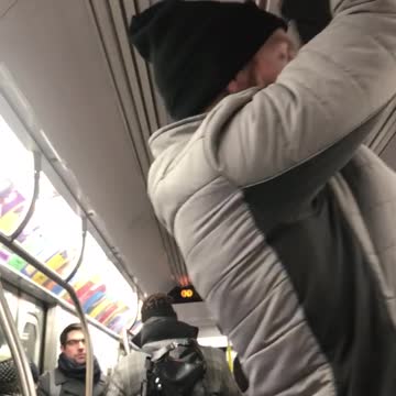 Guy does pull ups on subway train