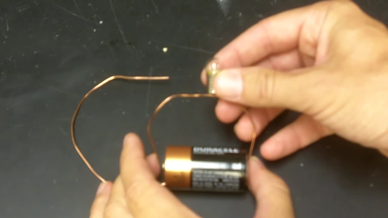 Here's how to get this light bulb to glow with a battery.