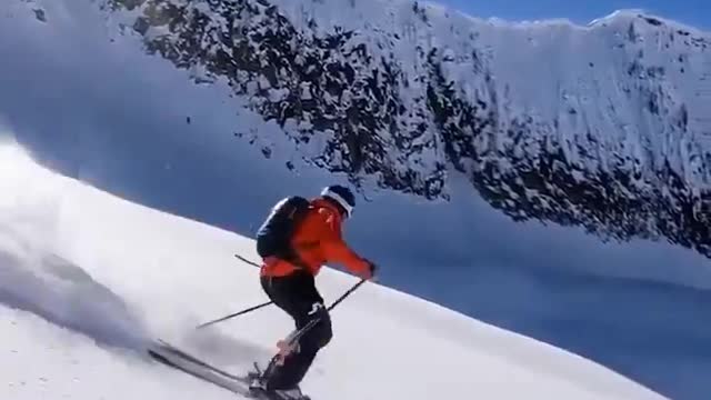 This videographer is shooting while skiing at 55 mph.