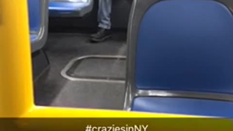 An older man back of bus talking to himself