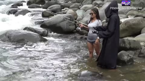 woman fishing for catfish in a fast current