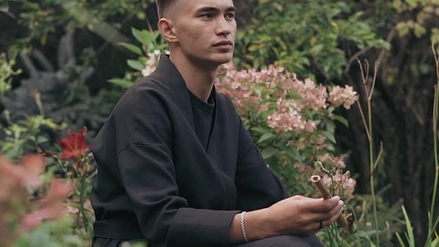 The boy is relaxing in a forest