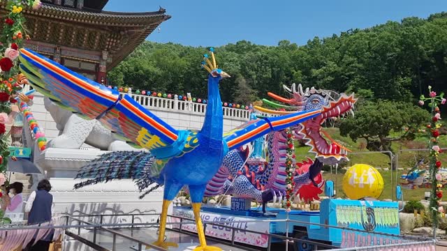 Phoenix and dragon sculpture moving at temple on Buddha's birthday