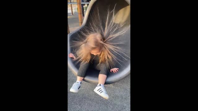 Slide's static electricity causes little girl to have insane hairstyle