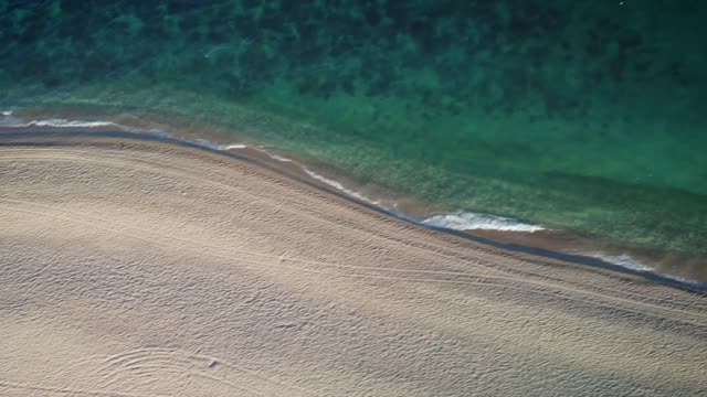View of the turquoise blue sea from a sunny beach