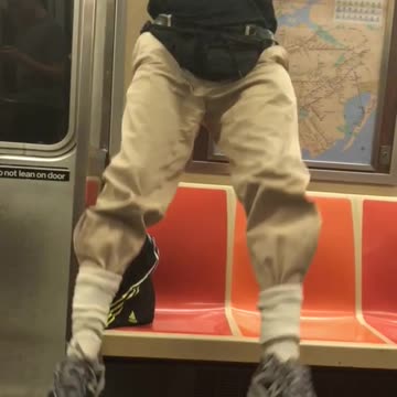 Older guy doing pull ups on subway