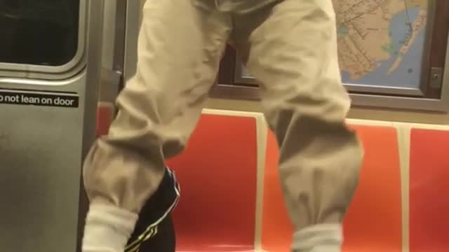 Older guy doing pull ups on subway