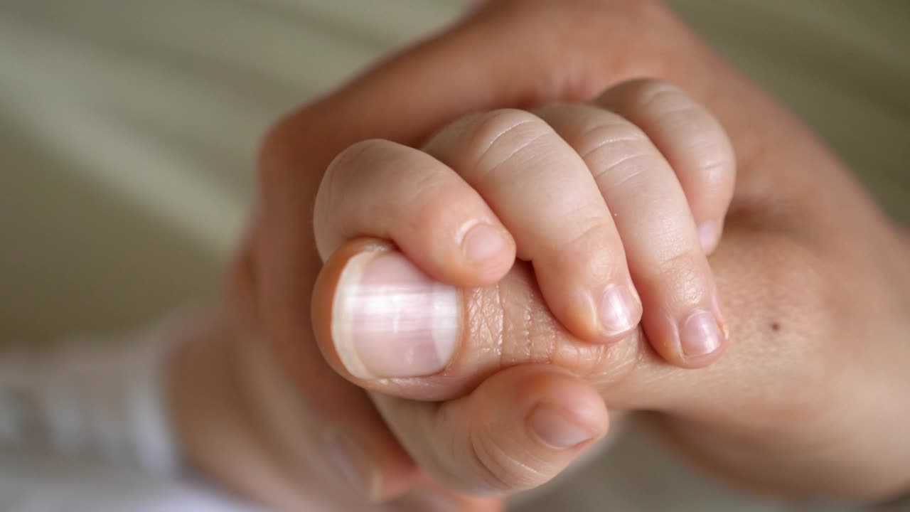 mother's hand holding us like this