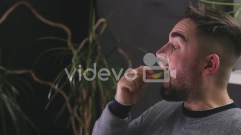 Hungry Man Sitting On Sofa And Eating Delicious Potato Chips 1