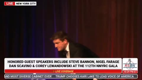 President Trump campaign advisor Alex Bruesewitz passes out on stage at NYYRC Gala