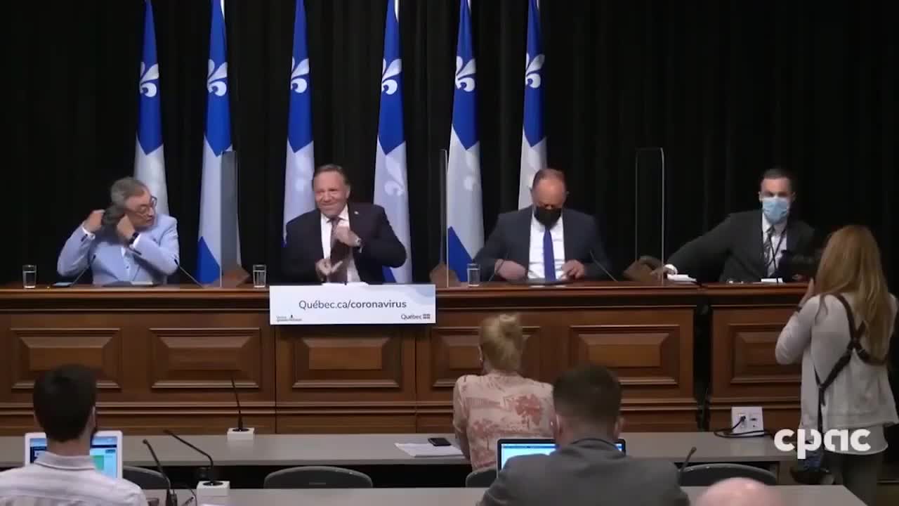 Canada- Quebec's Premier, throws the 666 sign out before sitting down