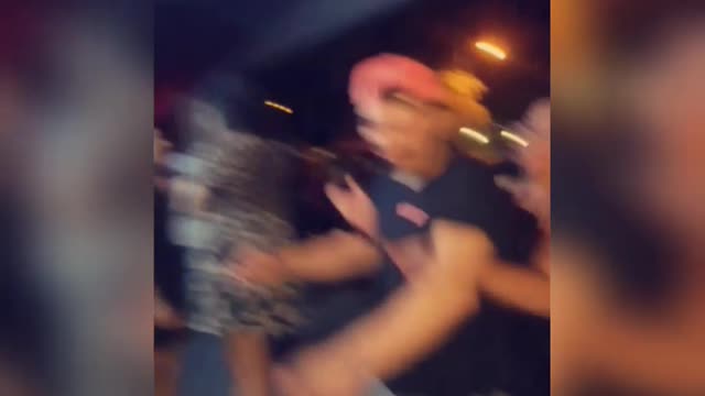 Music girl maroon shirt punches guy black shirt