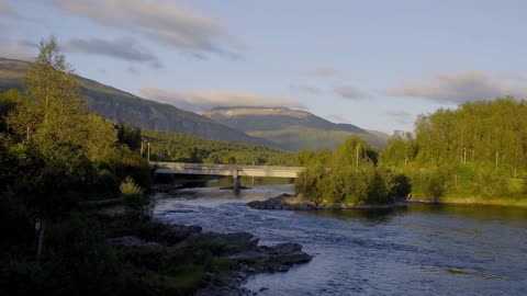 a bridge across a beautiful river in norway