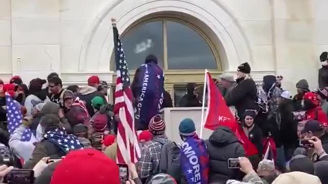 You can hear the crowd booing and demanding this person stop breaking the window at the Capitol