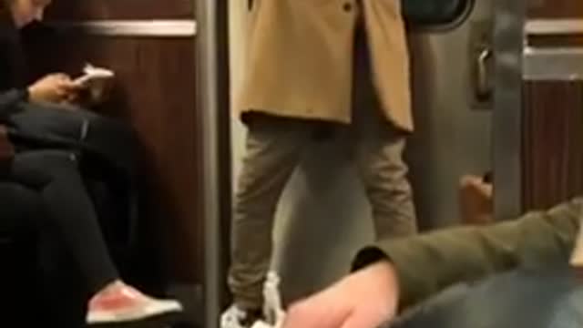 Guy wears vr headset on subway train and waves his arms around