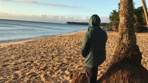 Guy looks at the beach.