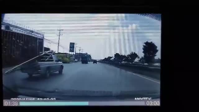 Truck Crossing Lanes with Fence Sticking Out of Truck Bed