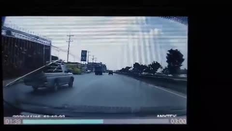 Truck Crossing Lanes with Fence Sticking Out of Truck Bed