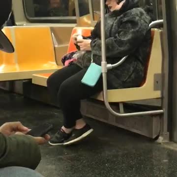 Woman on subway rubs egg on skin