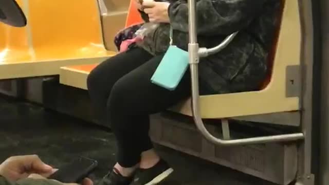 Woman on subway rubs egg on skin