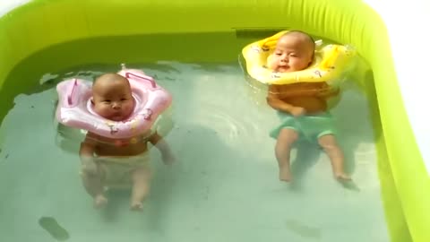 month-old twin babies enjoy pool time