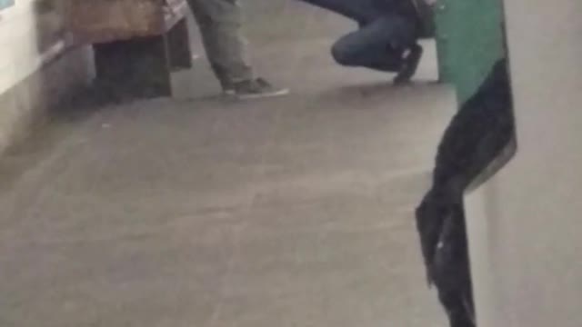 Two people exercising on subway station platform