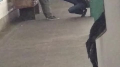 Two people exercising on subway station platform