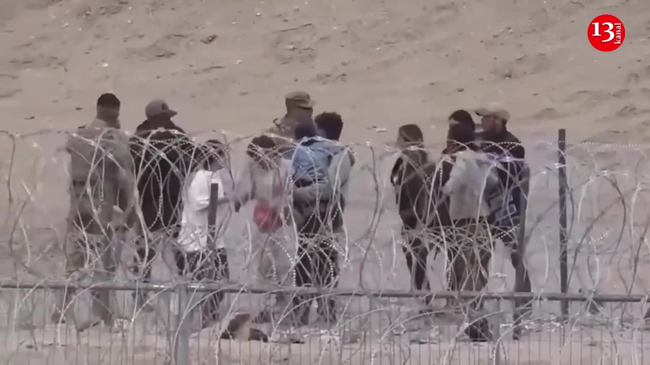 Drone footage shows barbed wire separating migrants and US National Guard in Texas