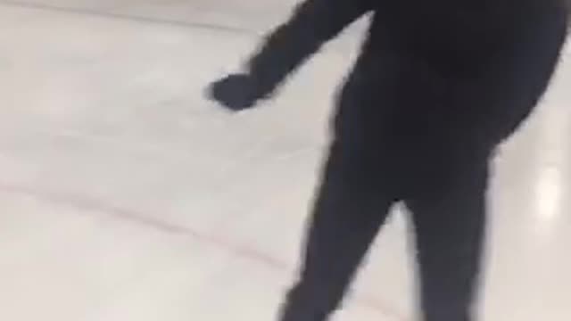 Girl black dances in ice skates and falls back