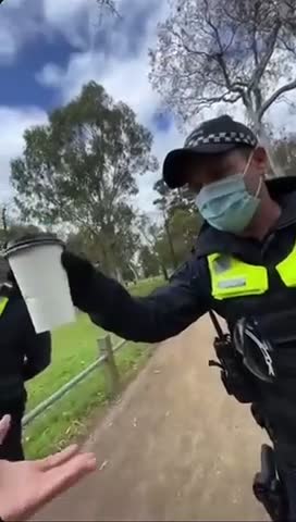 Police in Melbourne, Australia check a guy’s coffee cup to ensure valid mask exemption