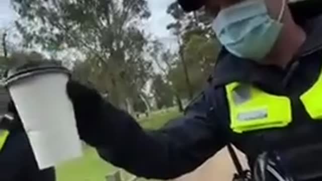 Police in Melbourne, Australia check a guy’s coffee cup to ensure valid mask exemption