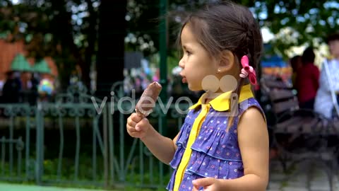 Little girl is eating ice cream