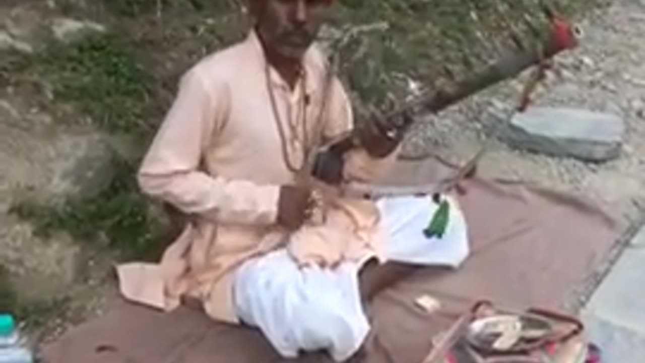 An Old Man Playing a Traditional Musical Instrument, Himachal, India