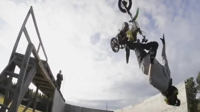 Guy motorcycle dirt bike back flip into foam pit almost gets hit by bike