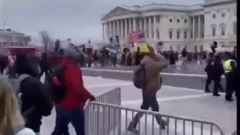 Police waiving people toward the capitol building