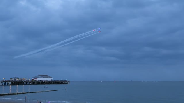 In Cloudy Weather Flying Airplanes on the Air Show on the Beach 🏖