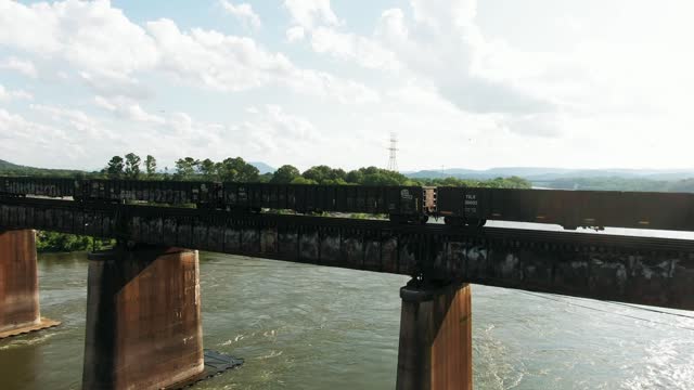 A Train Trams Crossing A Railroad Bridge Over A River