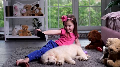 Young child with a puppy taking a selfie