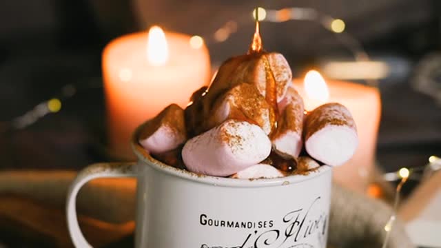 Pouring Caramel on Marshmallows on a Mug