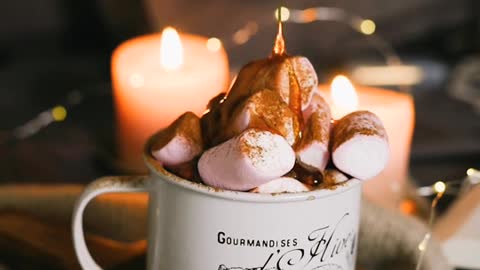 Pouring Caramel on Marshmallows on a Mug