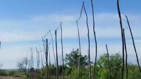 Russian supply road with nets screen against drones.