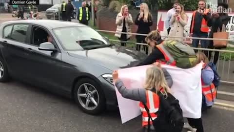 Furious drivers haul Insulate Britain protesters from road junction