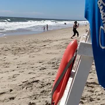 Guy in black punching air at beach