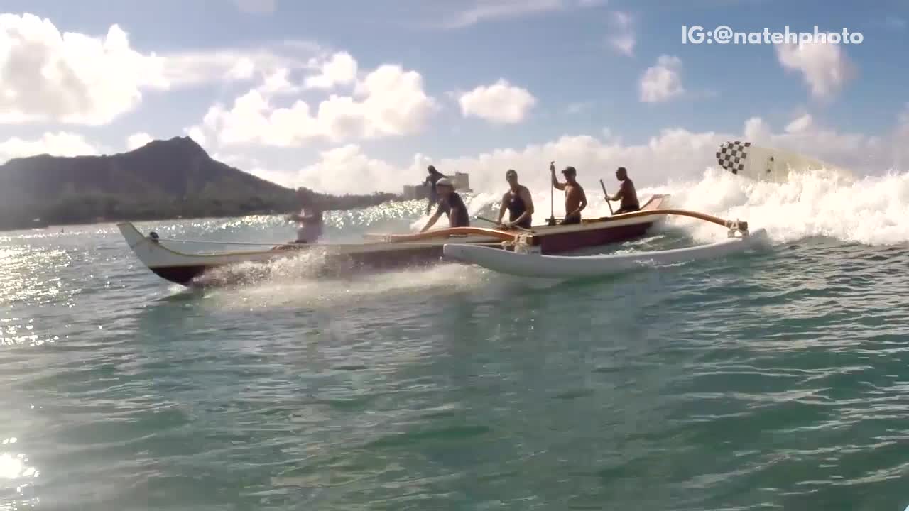 Huge canoe on beach waves