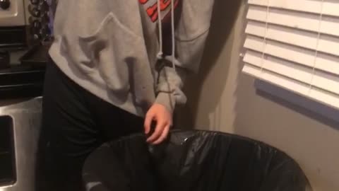 Nsfw guy grey hoodie throwing up in trash can